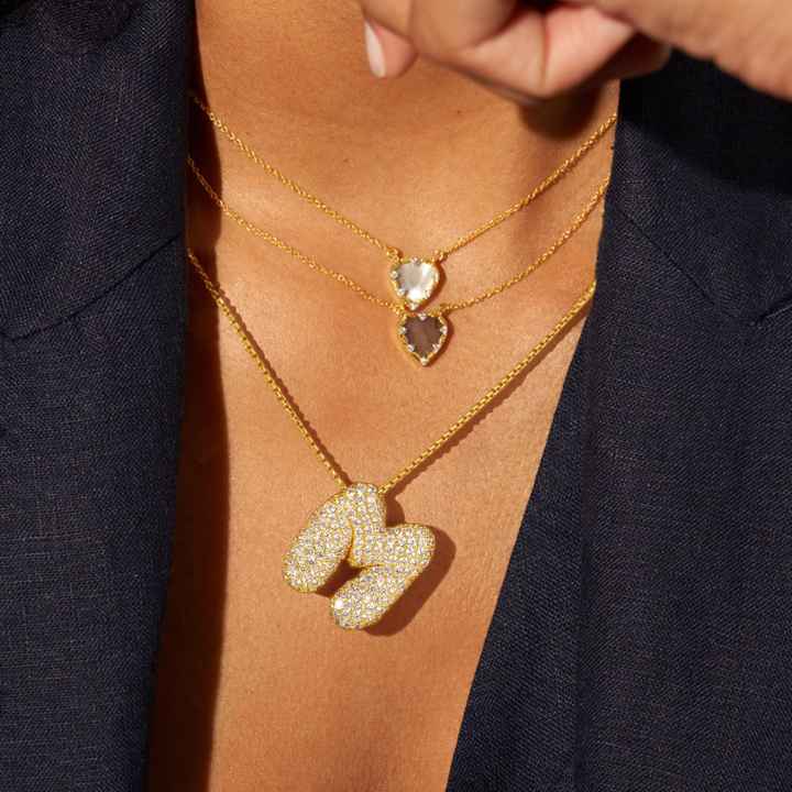 Melanie – Doble corazón en collar dorado