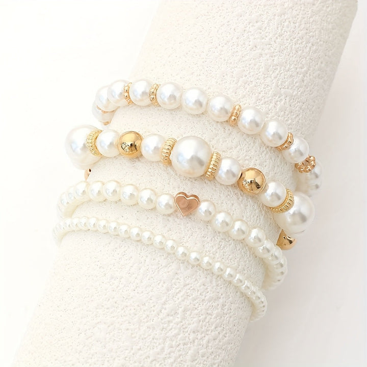 Juego de sofisticadas pulseras en forma de corazón con perlas