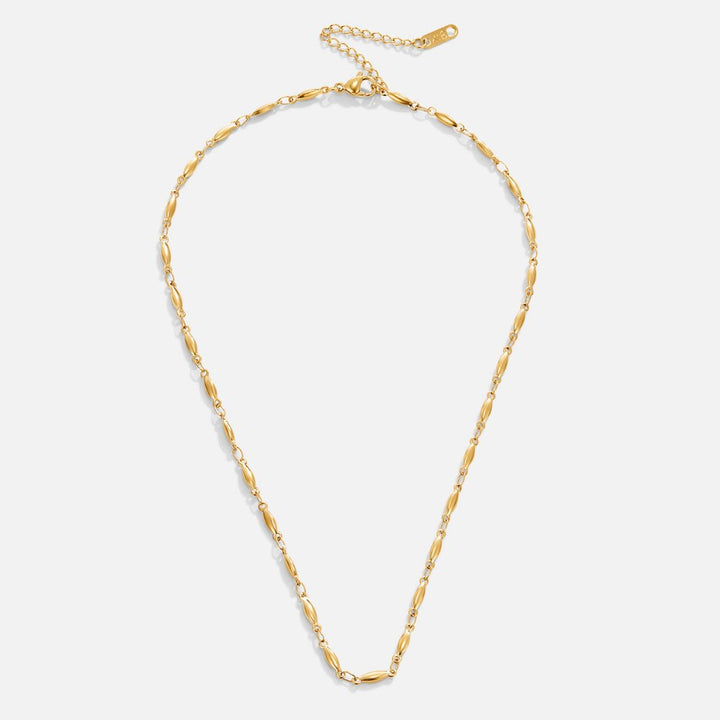 Frieda – Collana dorata con pendente a forma curva