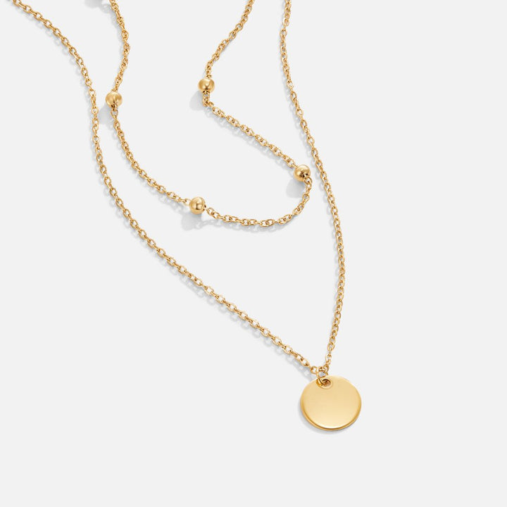 Leona – Doppia collana dorata con pendente rotondo