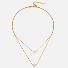 Doble capa de collar dorado con piedra oscura - Raúl & Sara Madrid