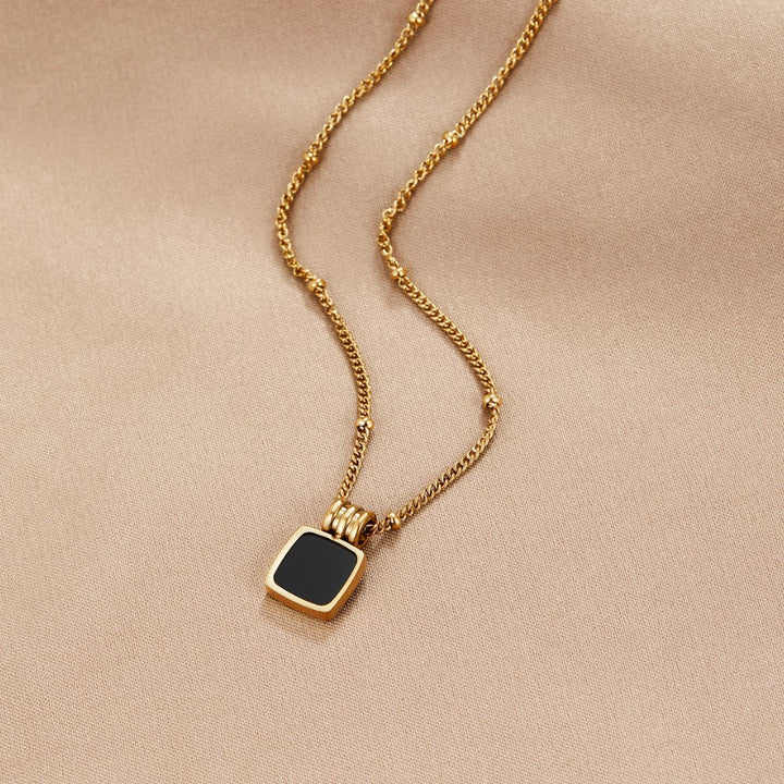 Selina – Collar dorado con gema oscura