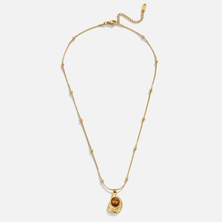Leonie – Cadena con colgante circular en oro.